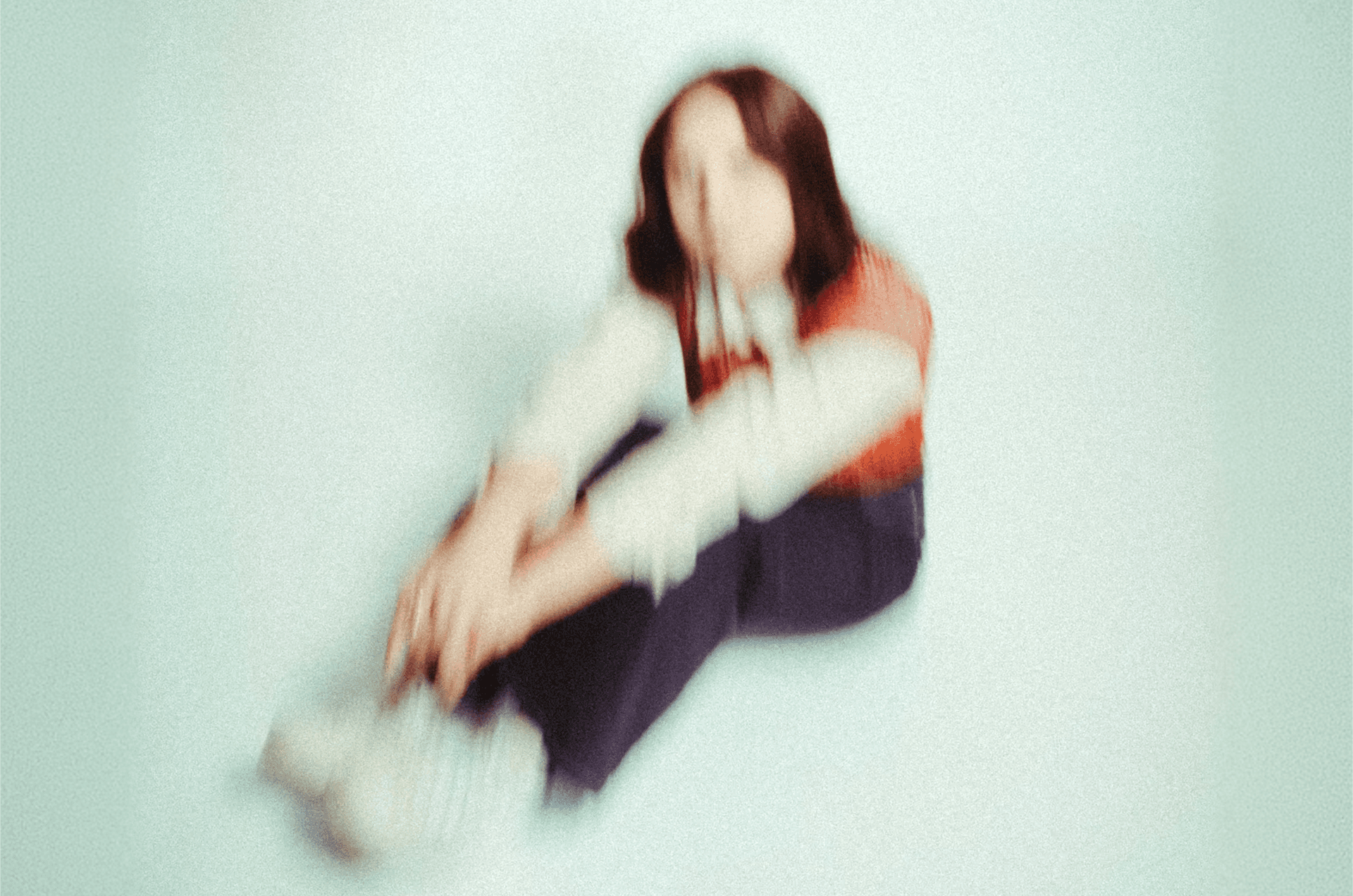 Blurred person sitting on the floor in a red-and-white top, symbolizing a standout B2B ABM campaign that captured attention and drove results