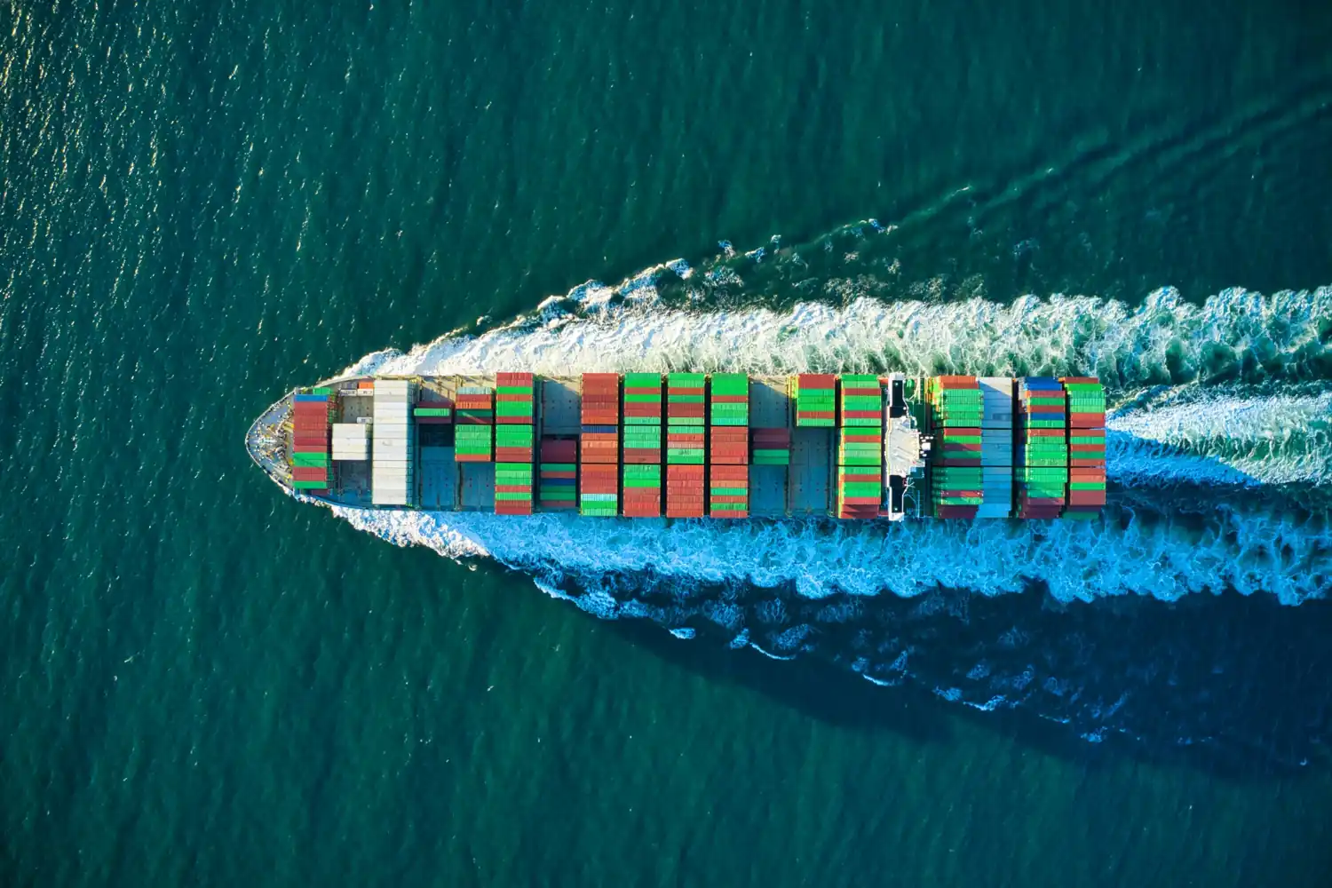 Container cargo ship transporting freight across the sea for international freight forwarding and global logistics.