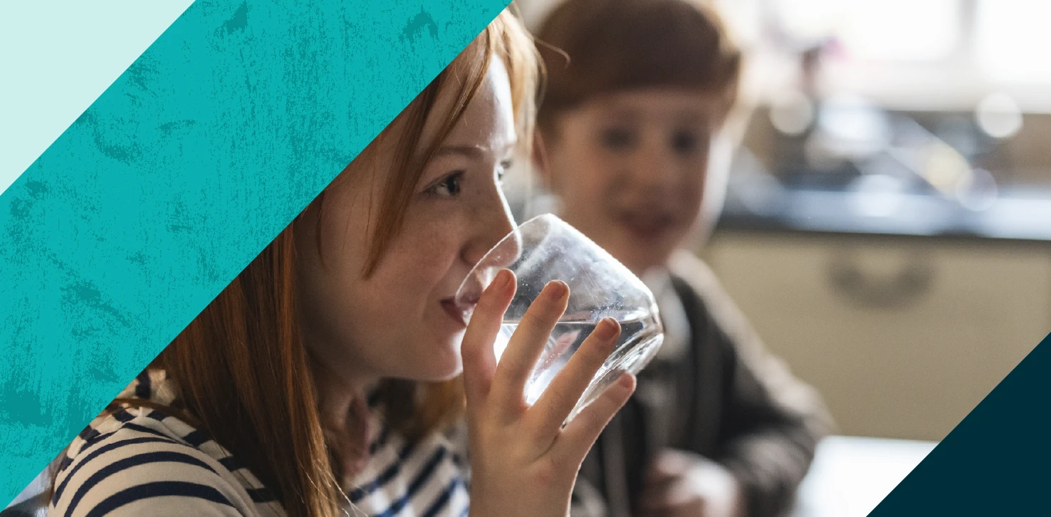 Little girl drinking glass of water