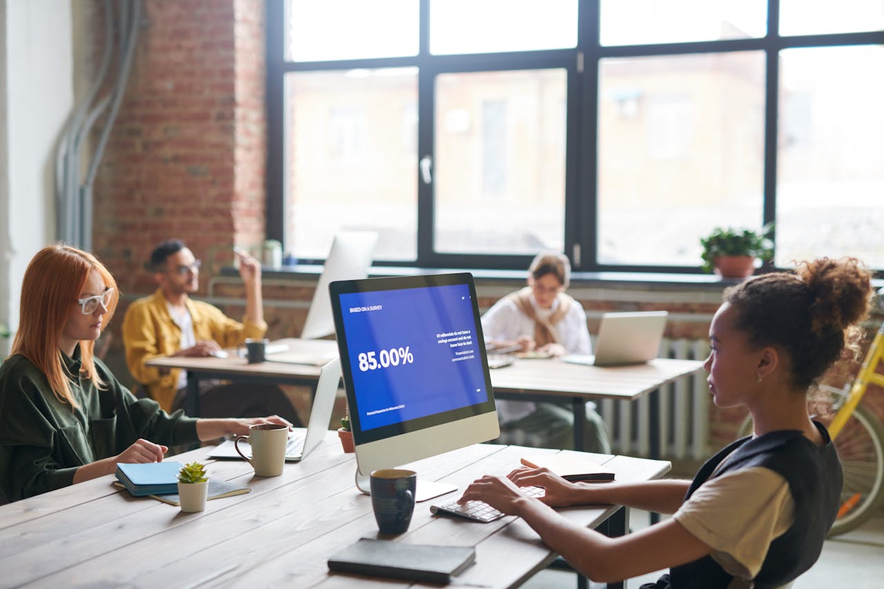 Office hall with people using their laptops and computers