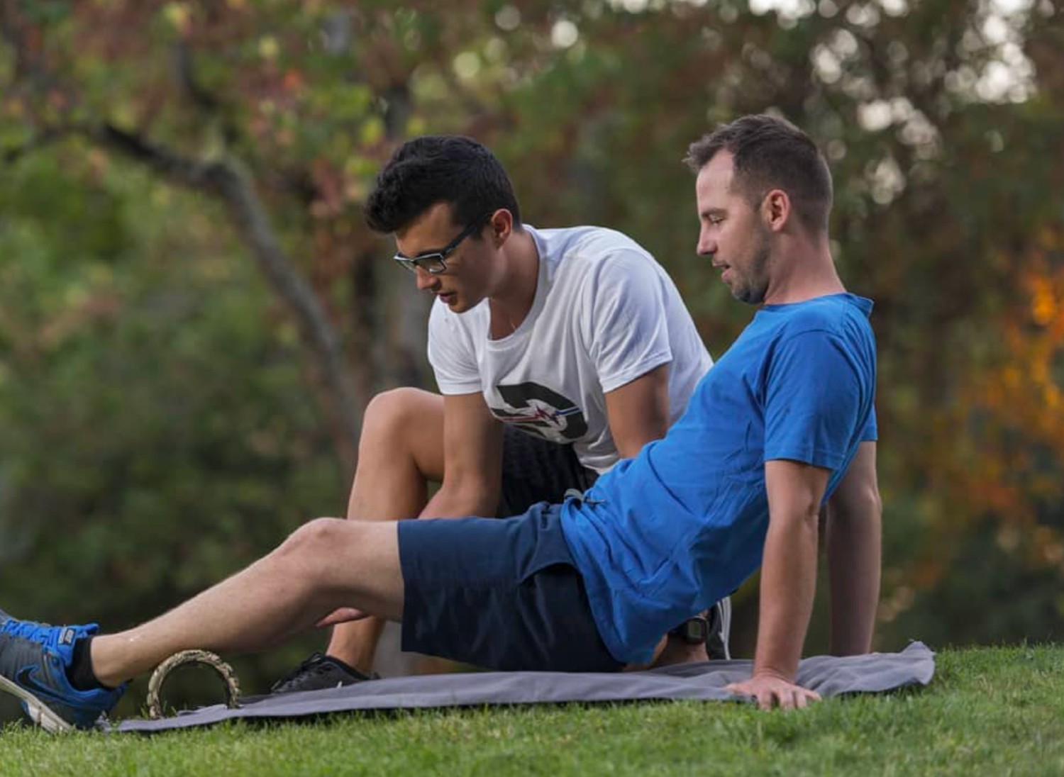 Personal trainer assisting client.