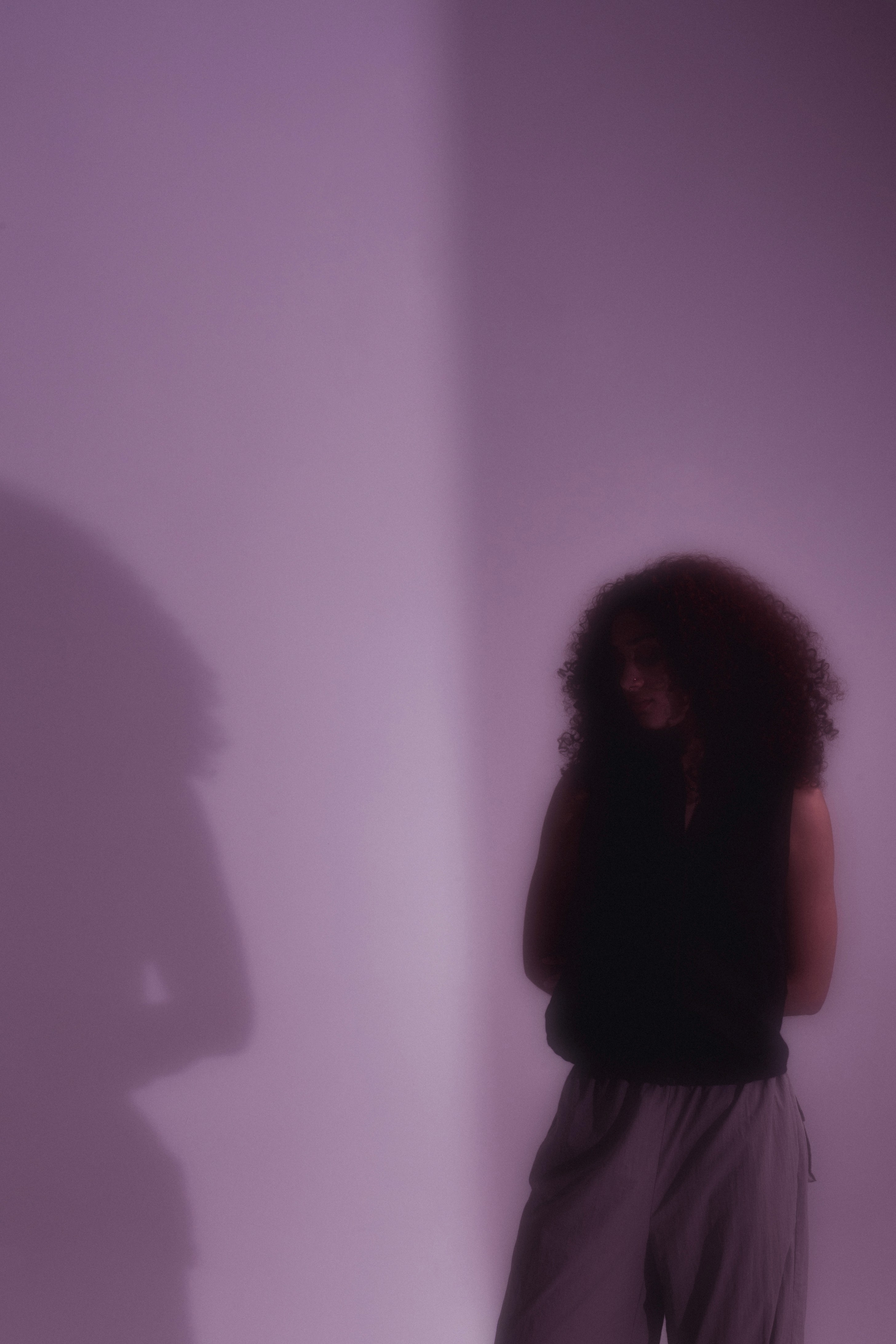 Artistic portrait with red and blue lighting creating a dramatic effect