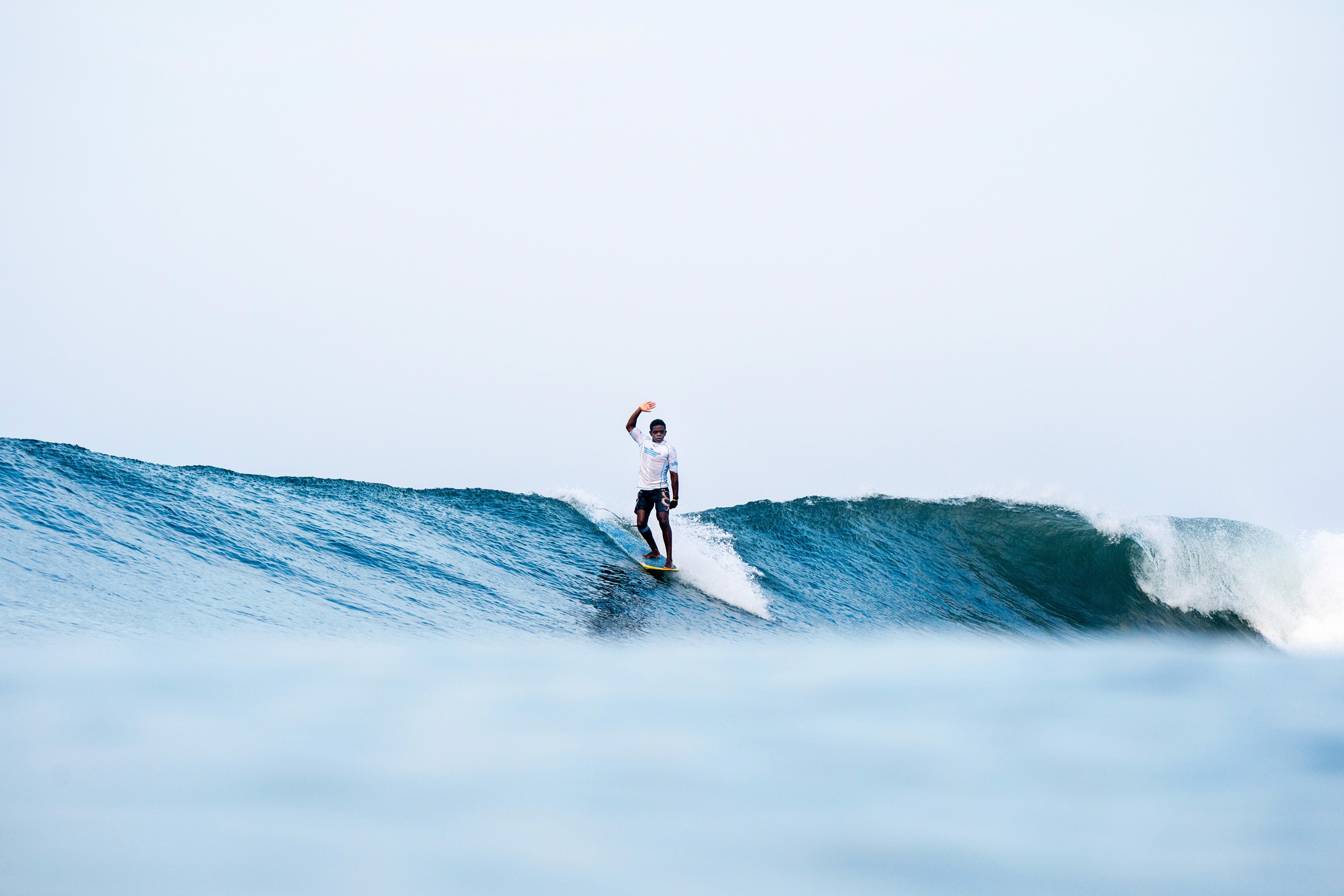A professional surfer, surf coach, surfing during a surf competition