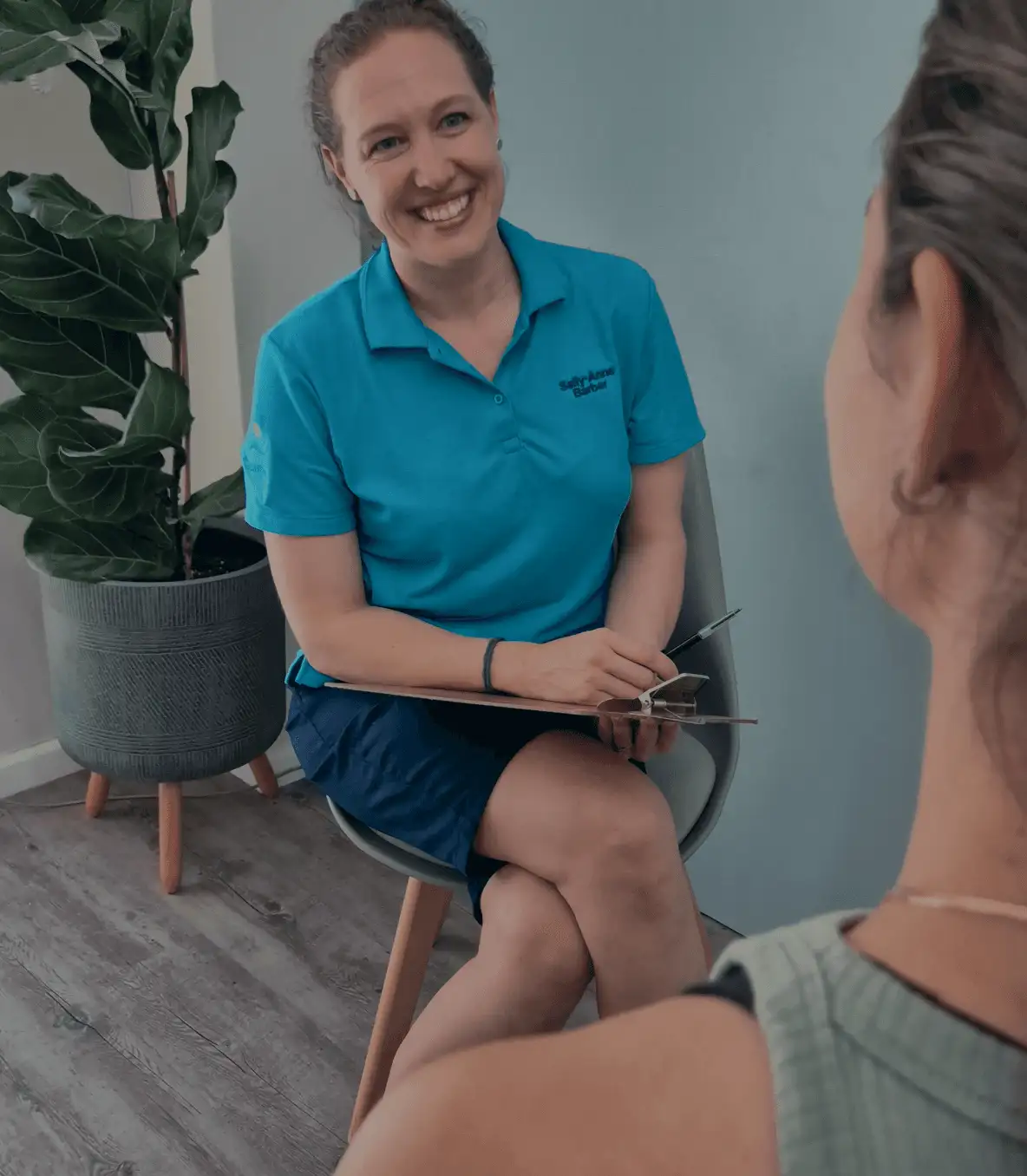 A Physical therapist sits down to discuss with a patient what their needs are in a short interview