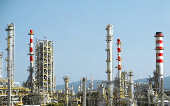 Oil and gas refinery equipment with processing towers and pipes
