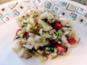 Chopped cucumbers with pomegranate pearls made into a salad.