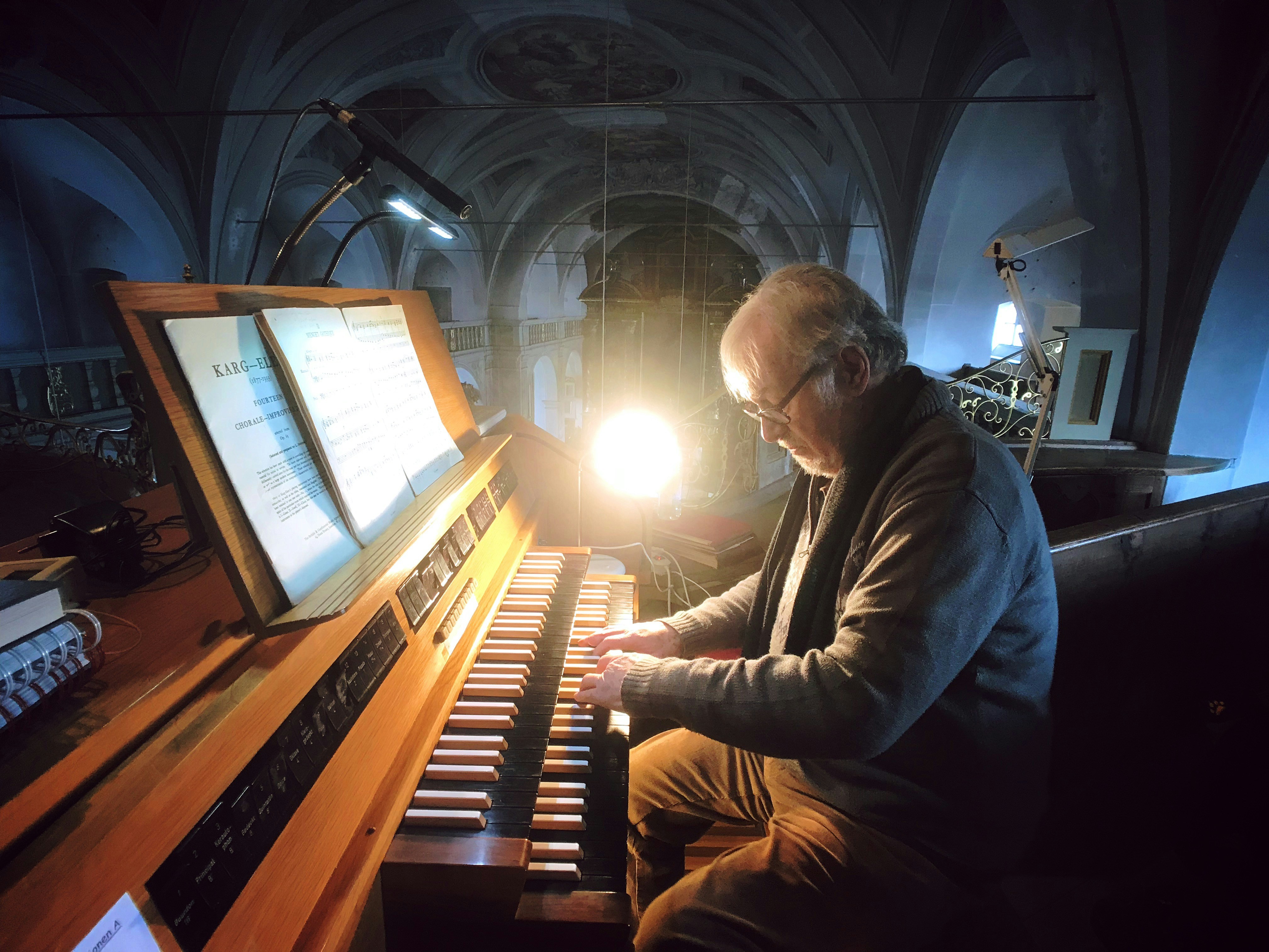 old man playing piano