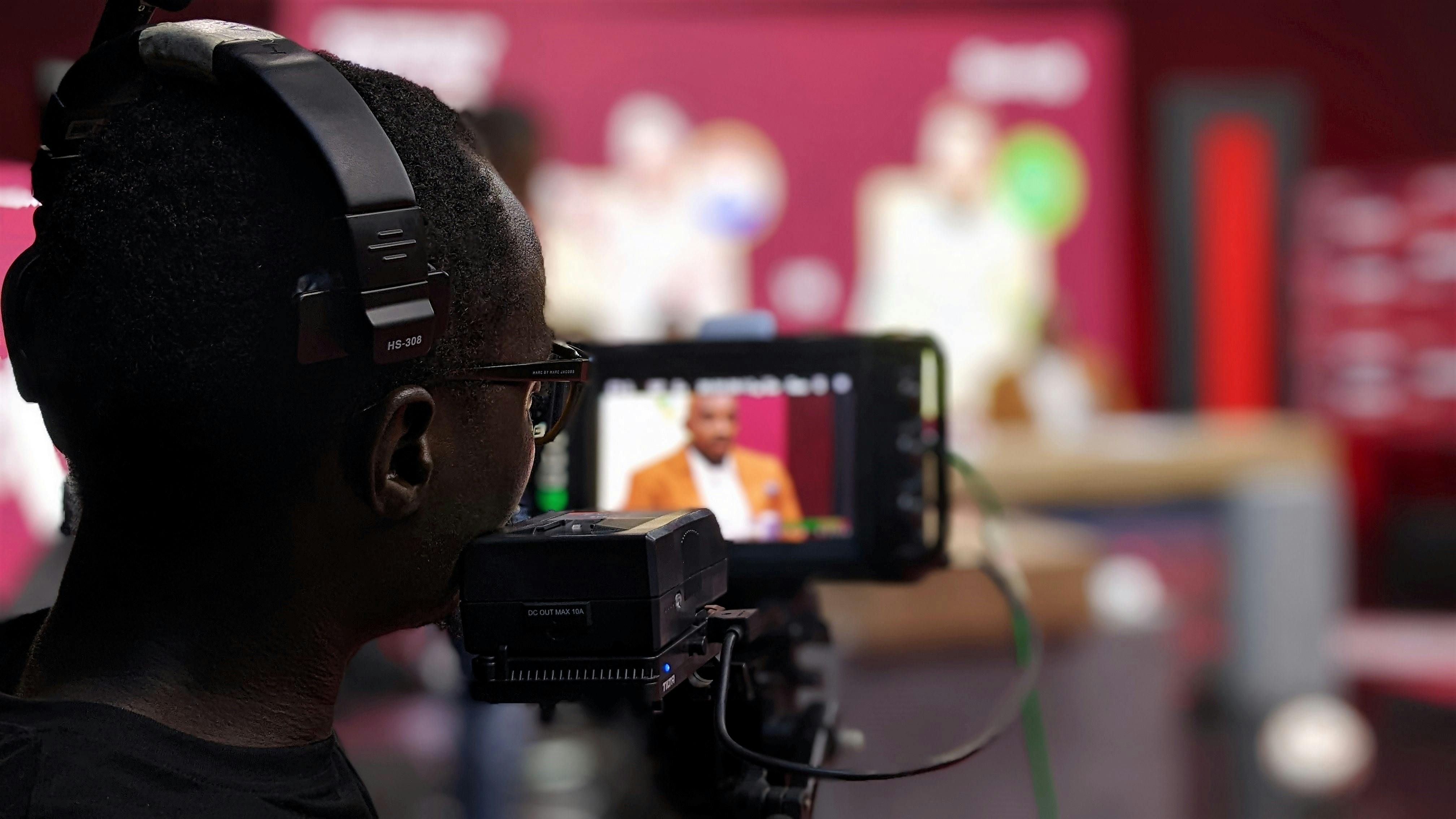 close-up-of-a-cameraman-with-headphones-filming-a-program-in-a-studio-setting. - isaiah-ekele (pexels)