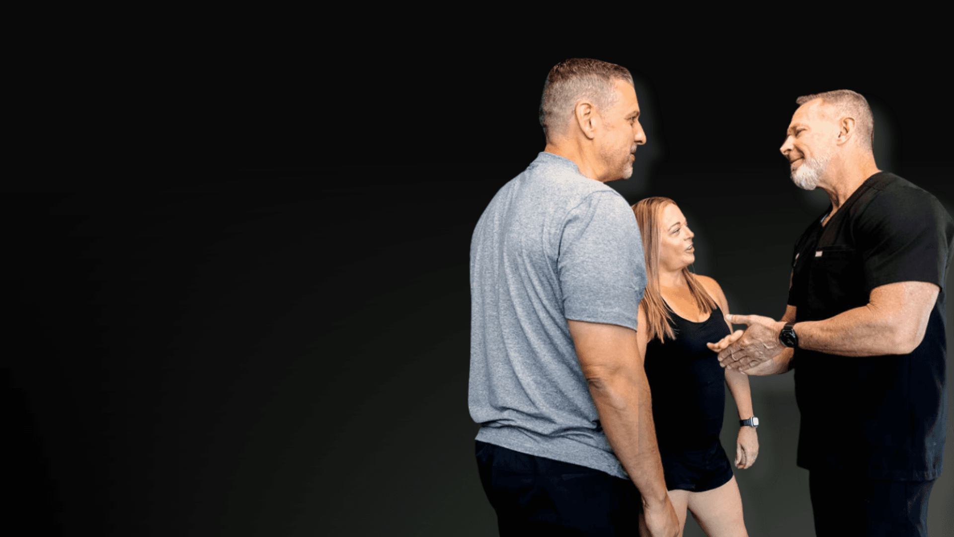 a staff member from elixium health talking with 2 people.