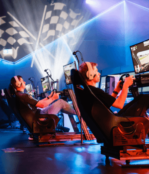 Multiple people playing on racing rigs