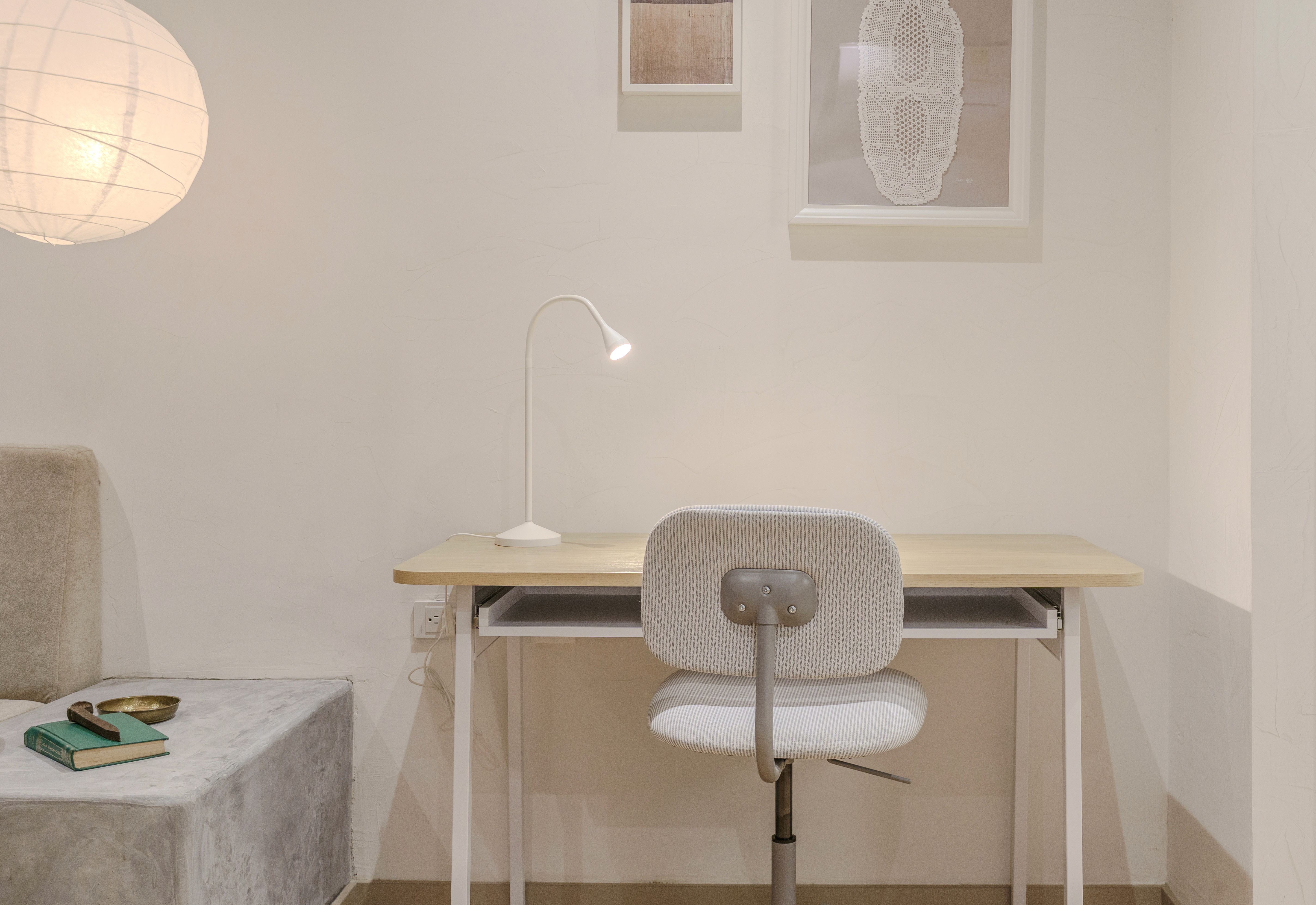 Double-height interior with flowing sculptural forms and warm raking light