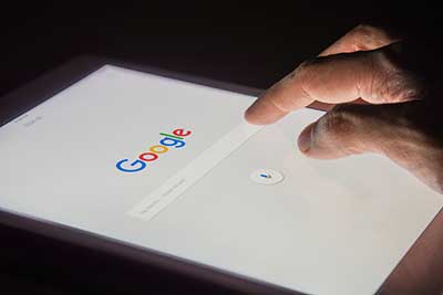 Person searching google on phone