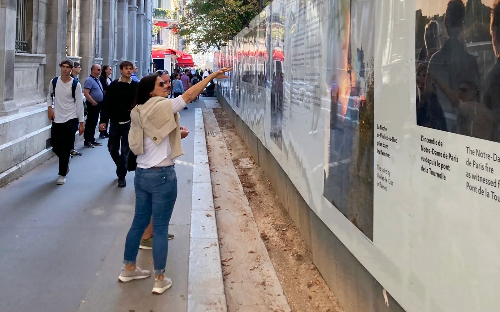 游客们在巴黎街头参加导览时,参观历史展览。