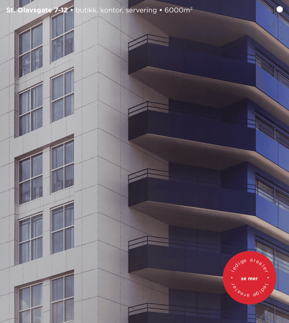 Closeup of a building with windows on the left and blue balconies on the right.