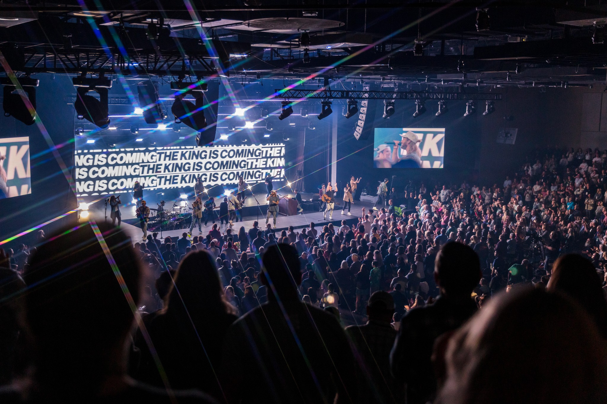person sitting on grass and using phone