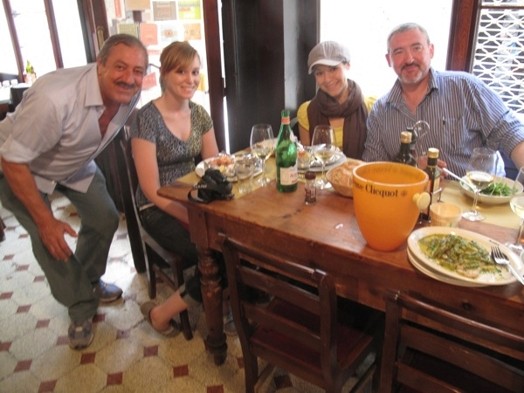 A photo of a group of people in a restaurant.