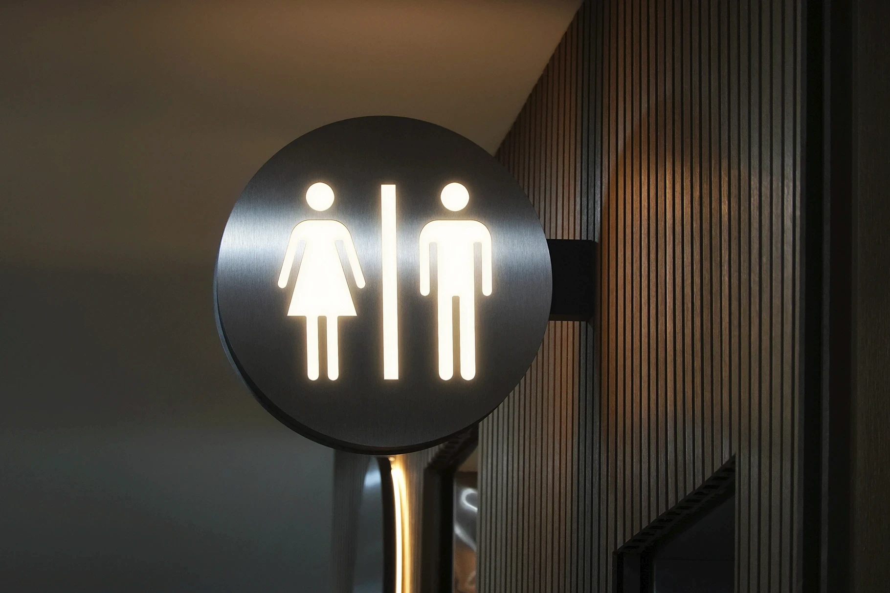 Glowing metal sign mockup with an abstract three-line logo.