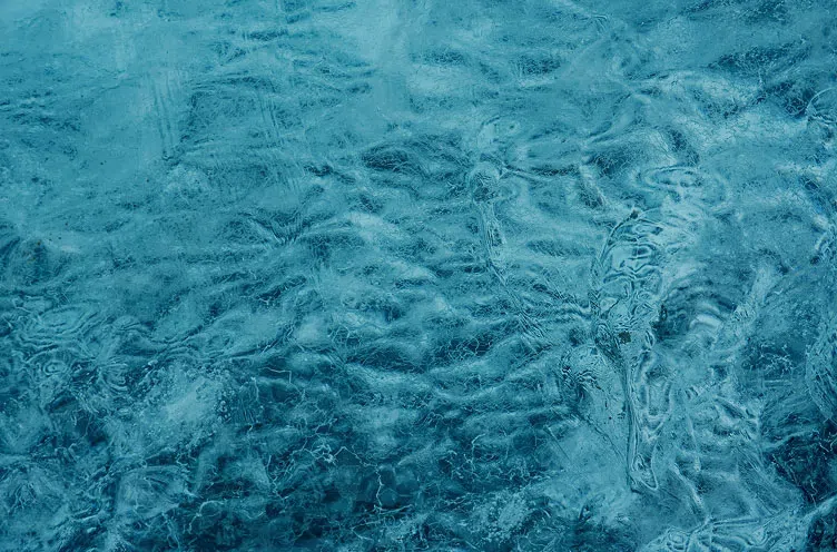 Abstract texture of deep blue glacial ice