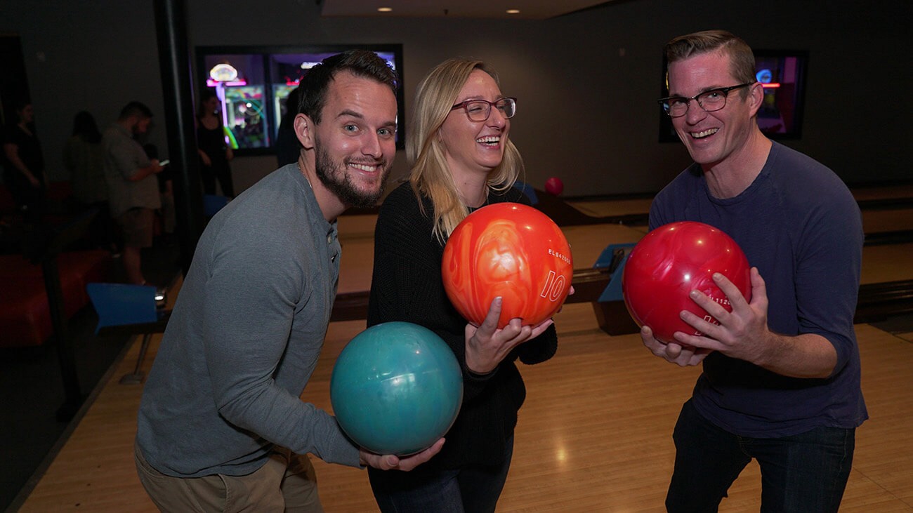 Co-workers bowling at a company event