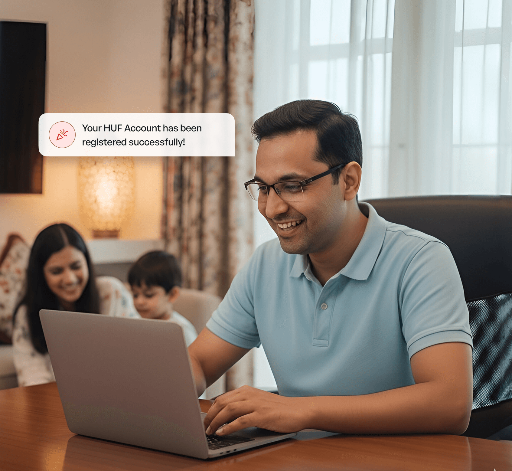 Man smiling at his laptop after receiving a 'HUF Account registered' notification.