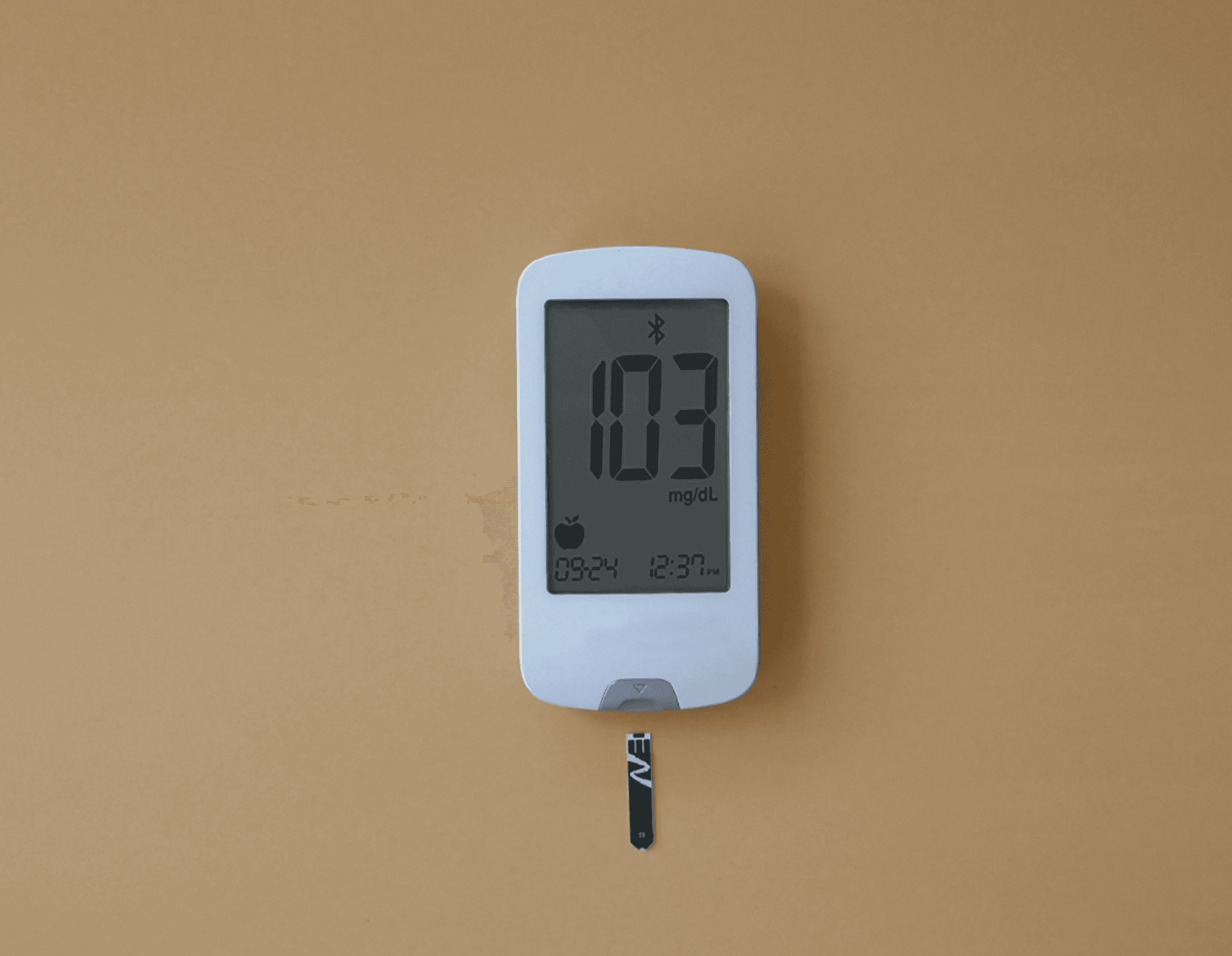 a digital thermometer on a tan wall