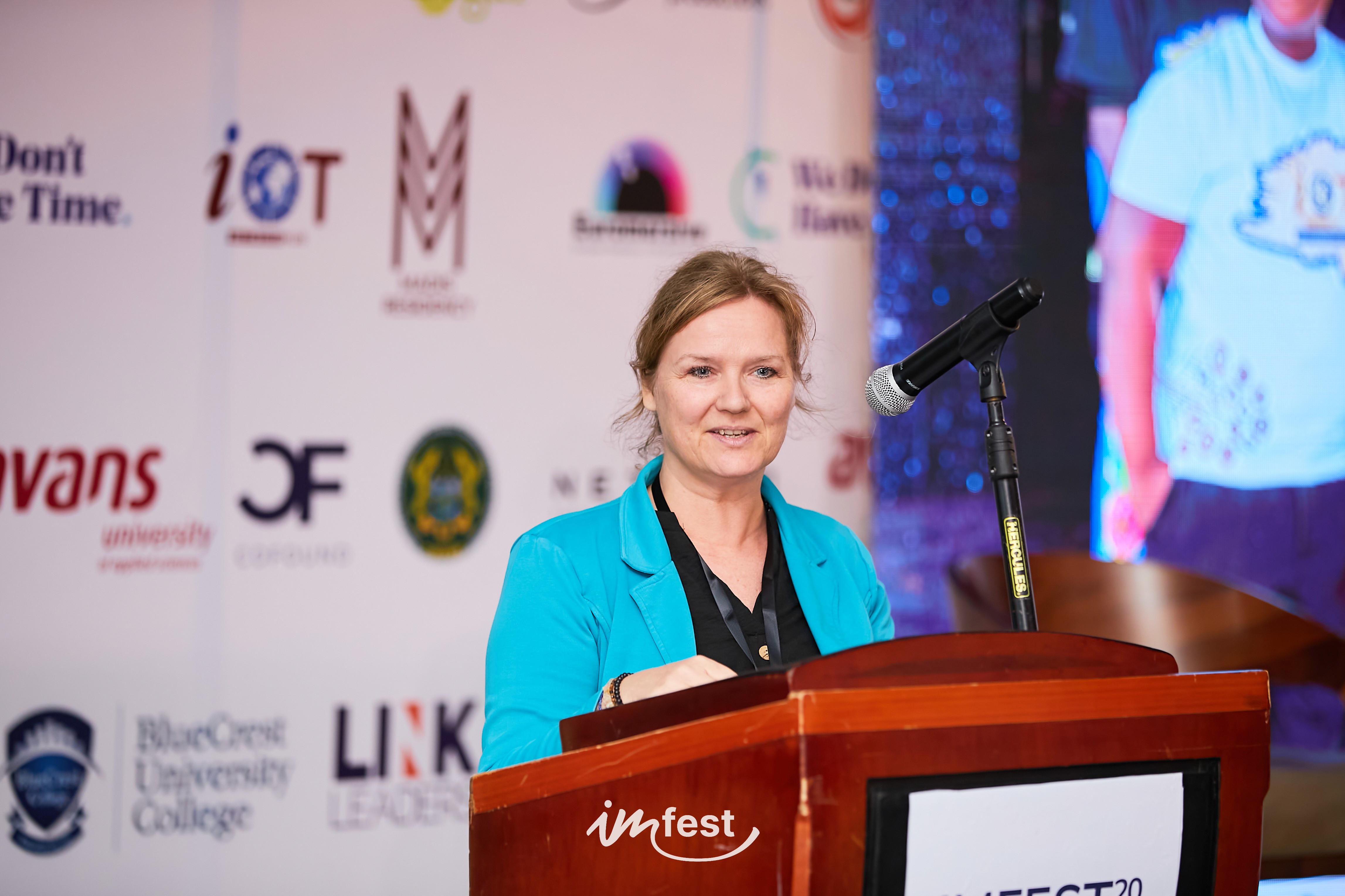 A person stands in a sandstone cave.