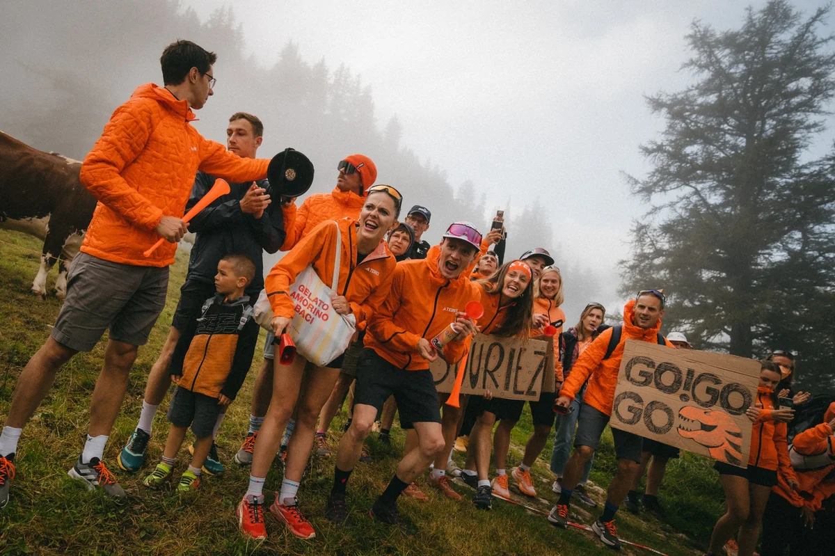 Adidas Terrex supporters cheering on runners with signs and accessories along the UTMB course