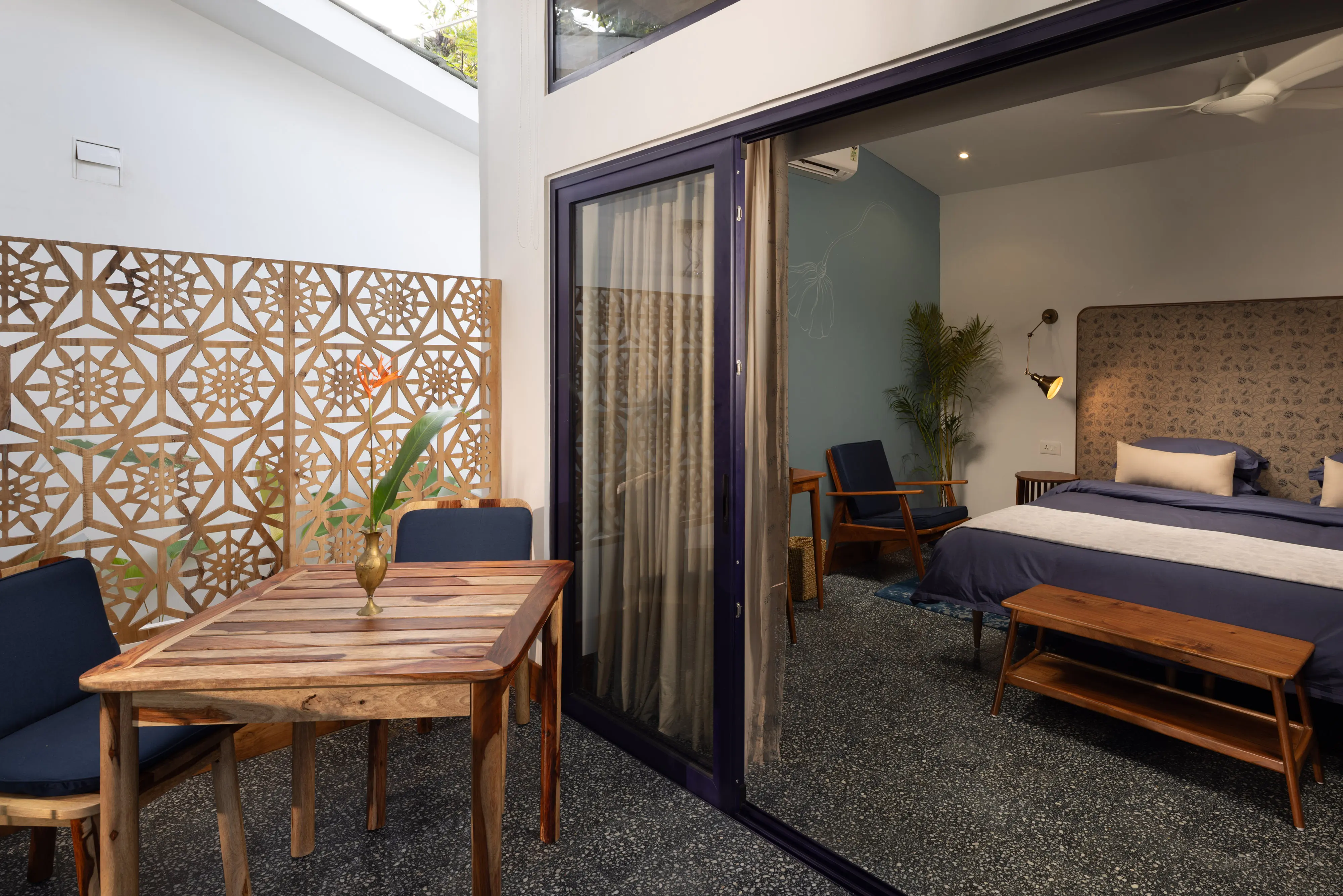 Room Four at Jaali Blue — bed beside the carved jaali divider