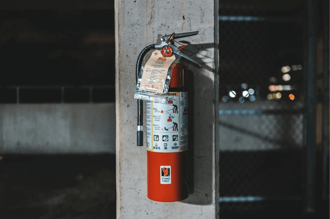 Inspected fire extinguisher on a column