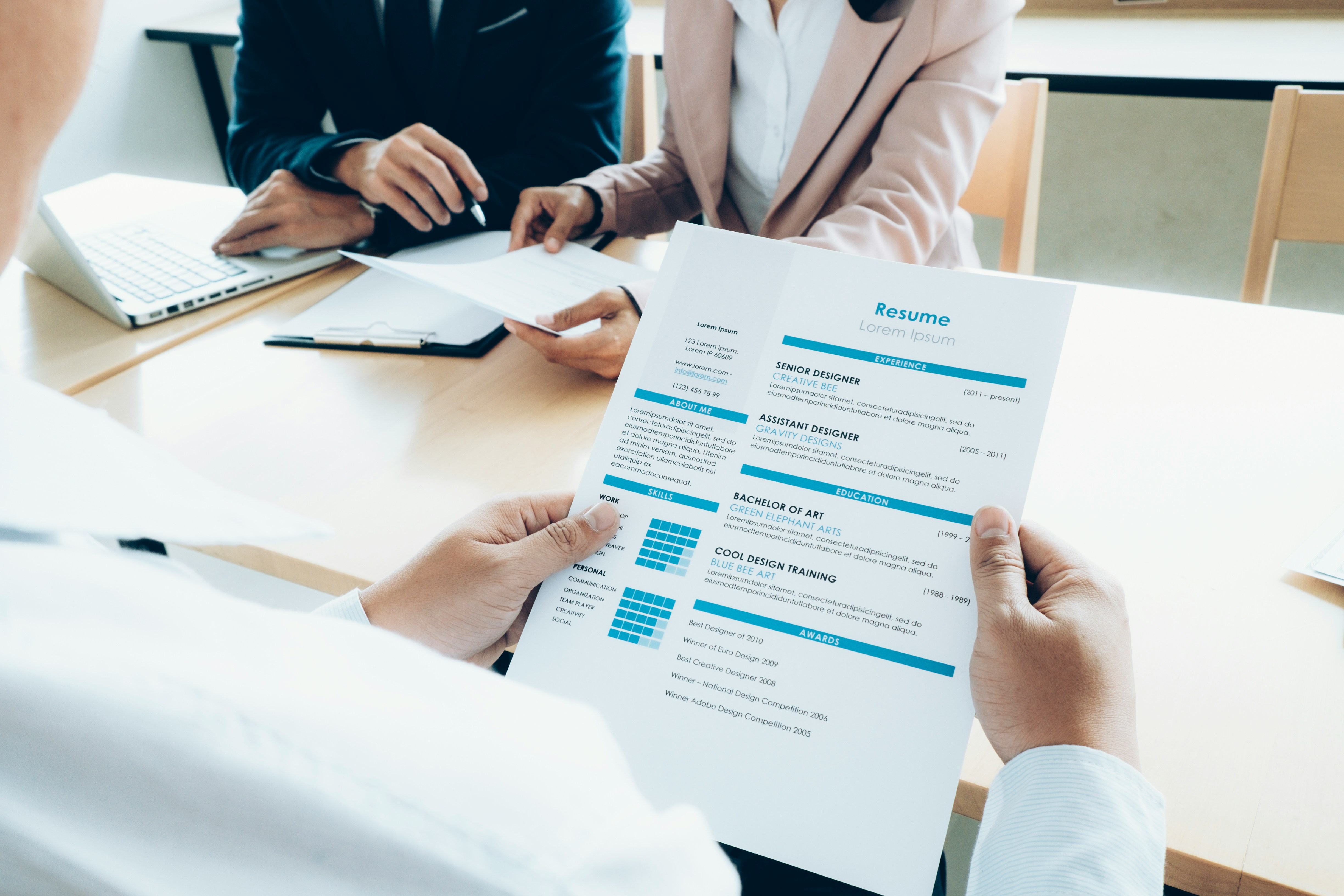 Candidate holding a resume during a job interview.