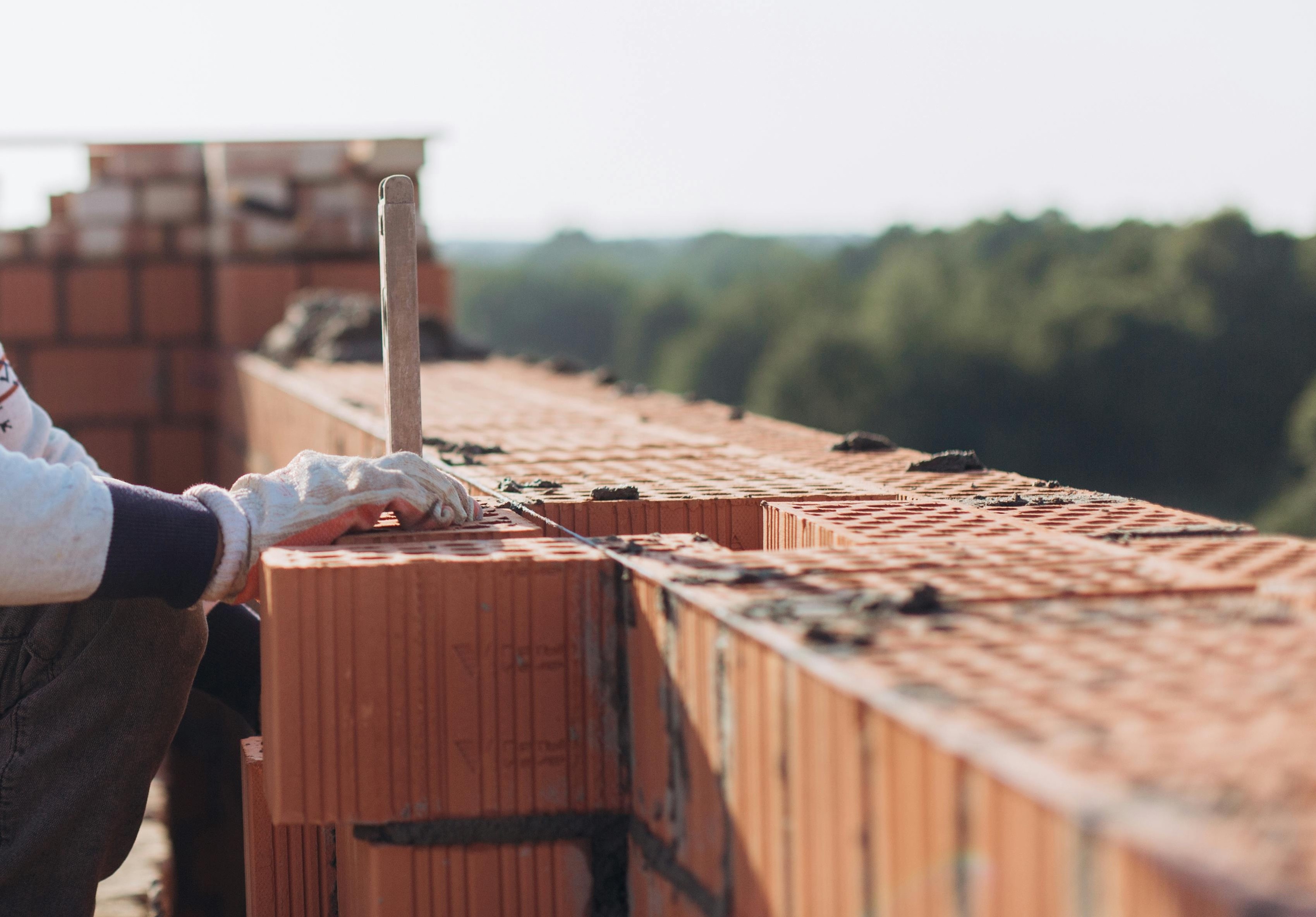 brick worker laying down stones
