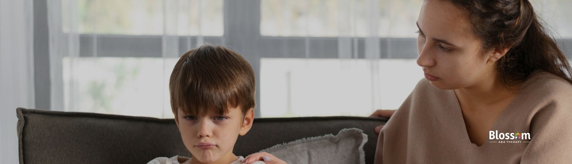 A woman consoling a boy looking sad and stress