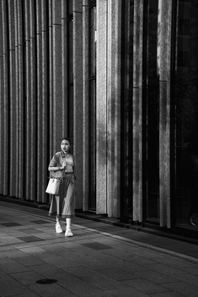 Model posing with the sunset hitting (black and white)