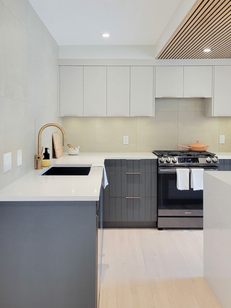 Image of Modern kitchen with white countertops, gray cabinets, and luxury design elements by KHD Homes.