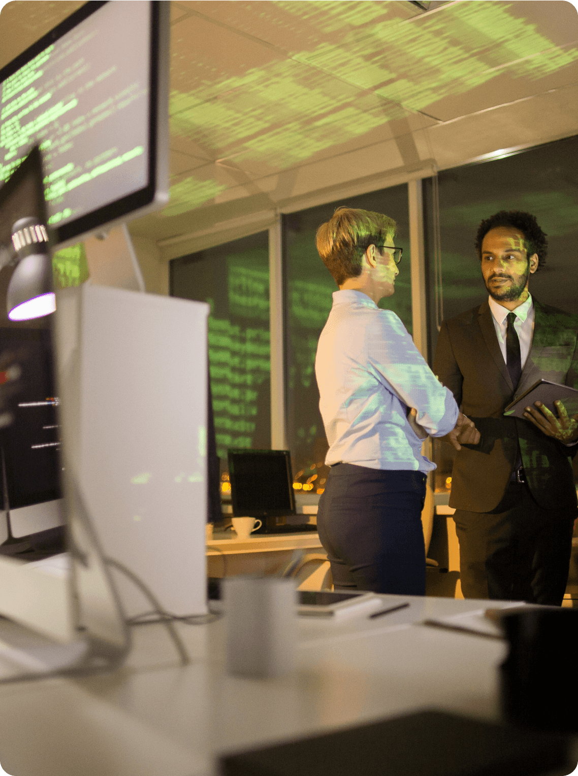 A man and a woman working in a server room 