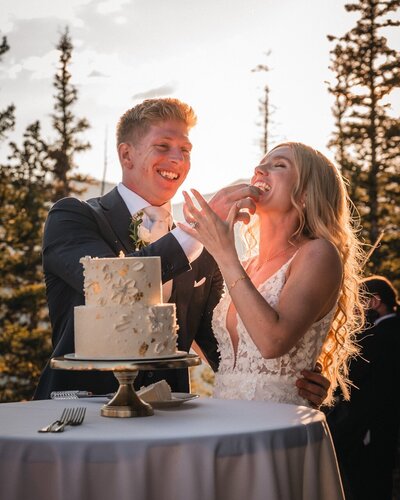 The newlyweds laugh as Tucker feeds Clemmie a bite of wedding cake.