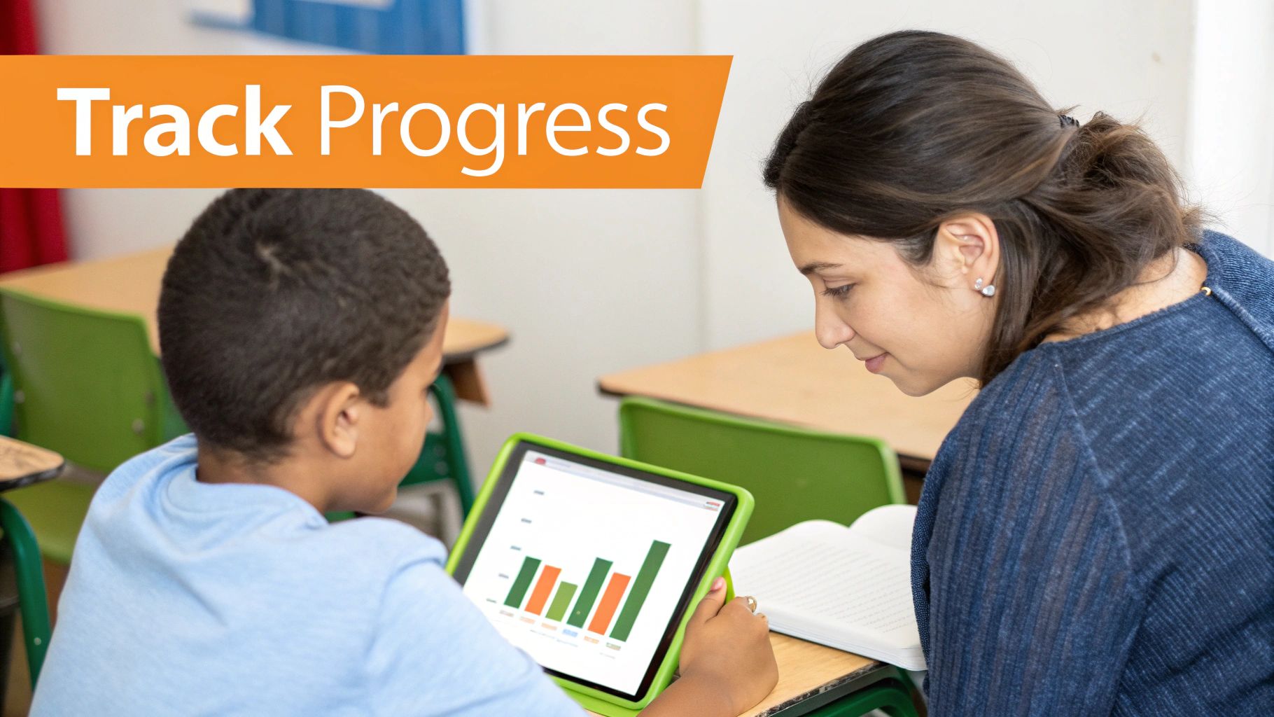 An adult and a student collaboratively track progress on a tablet with a graph in a classroom setting.
