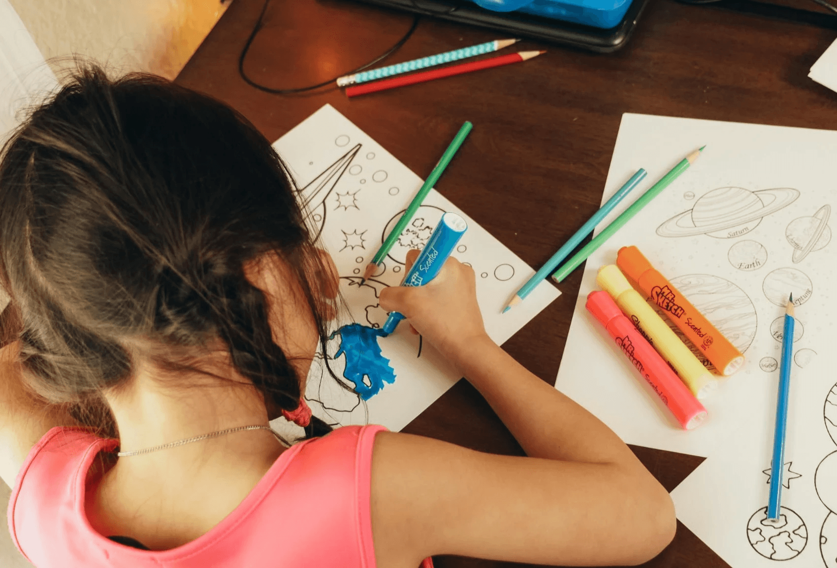 Child coloring an activity sheet.