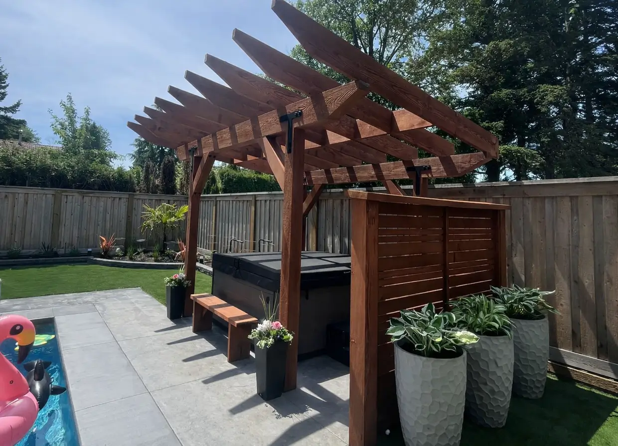Custom backyard pergola with hot tub seating area, privacy screen, and modern landscaping.