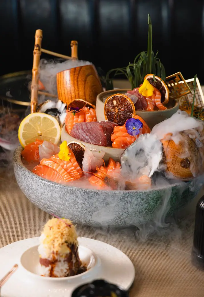 Sashimi platter on ice, wreathed in smoke