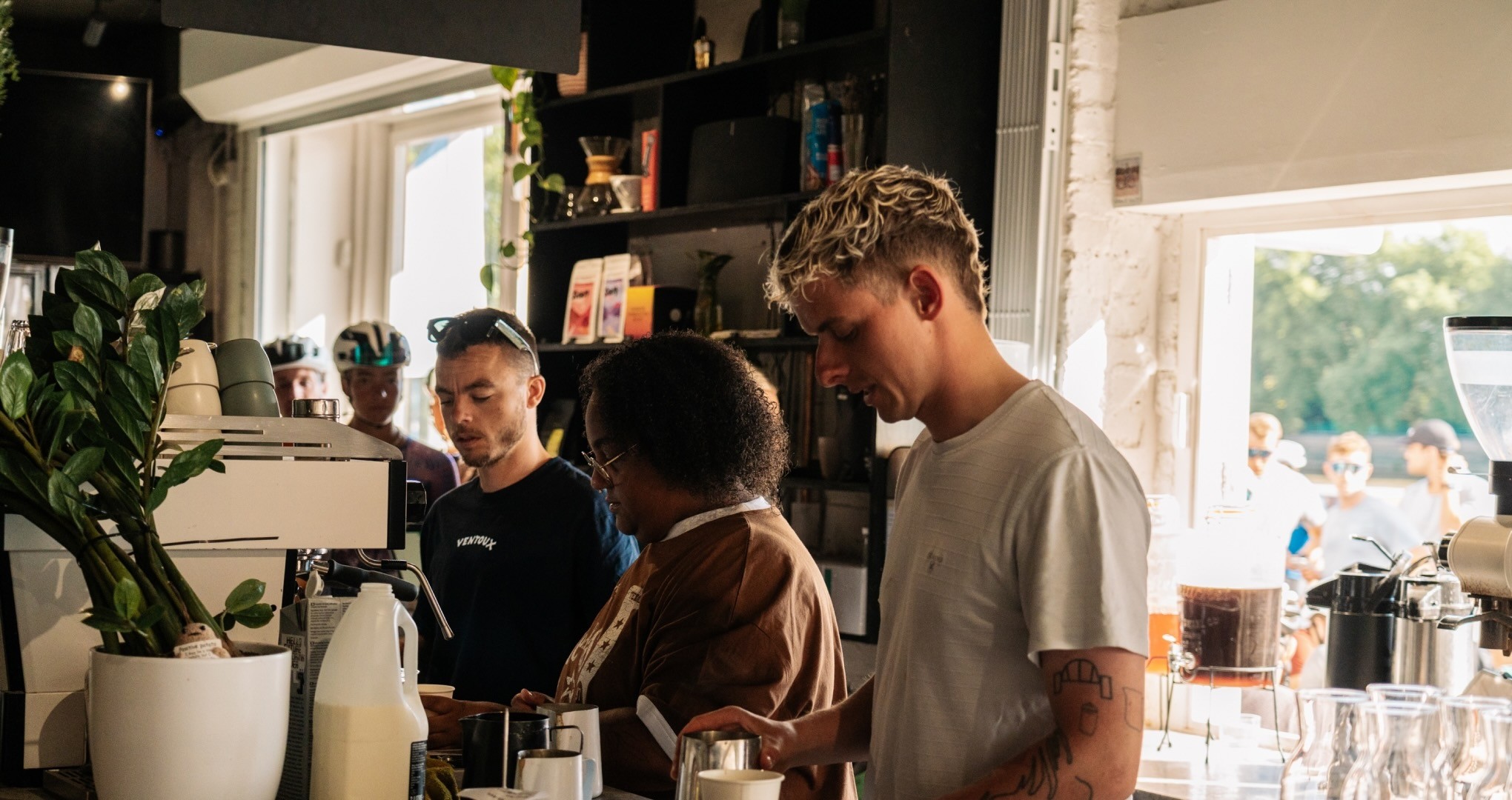 three person holding beverage cups