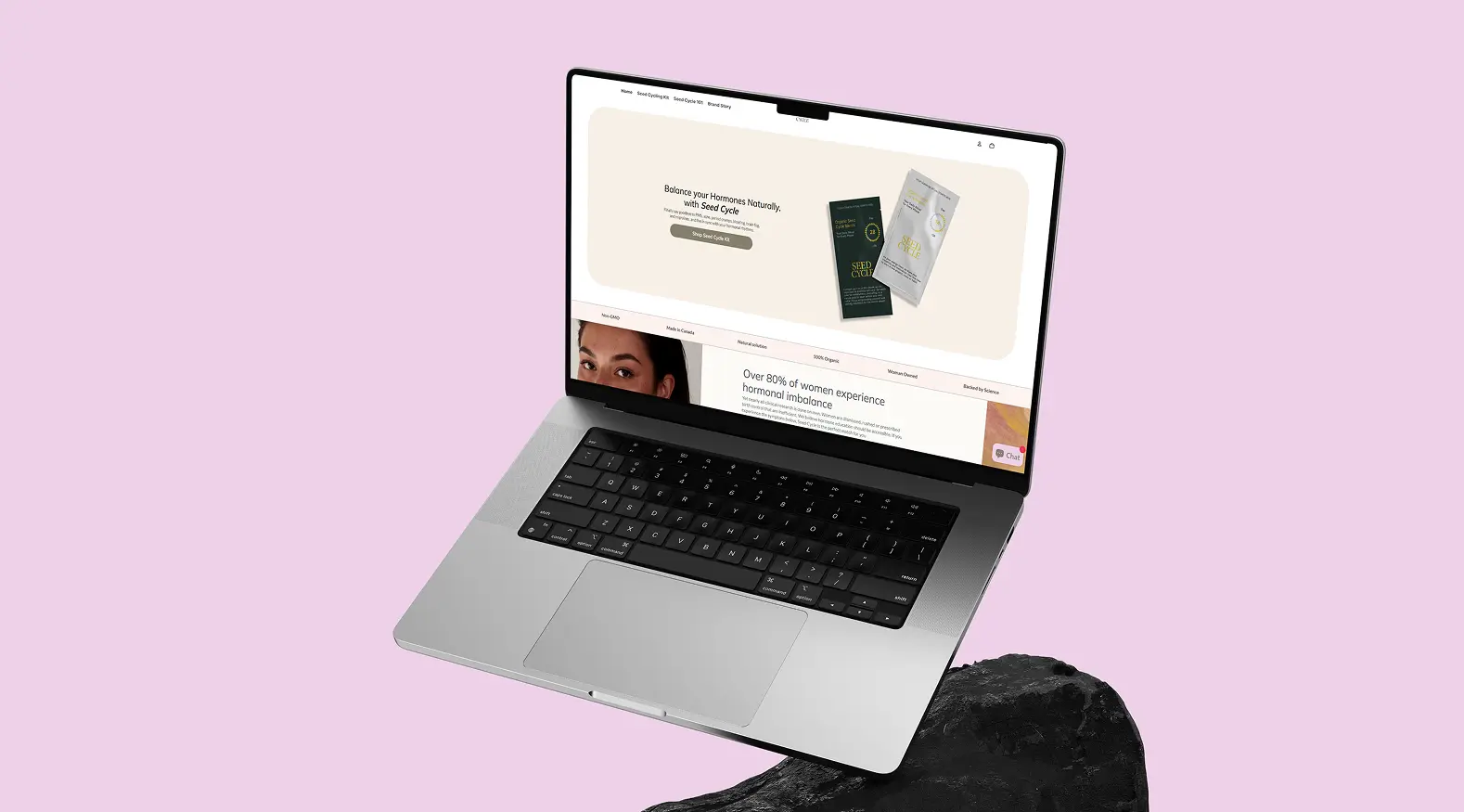 Mockup du site web Seed Cycle affiché sur un ordinateur portable — page d'accueil avec le slogan "Balance your Hormones Naturally, with Seed Cycle"