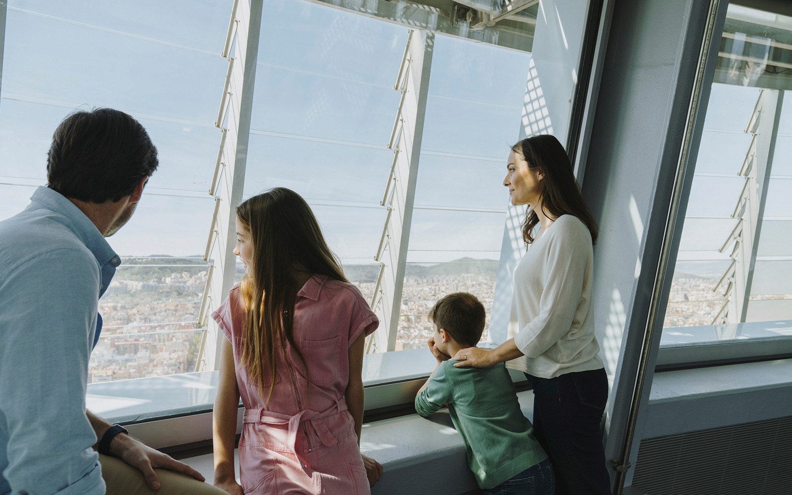 Family enjoying city view from Torre Glories Lookout in Barcelona.