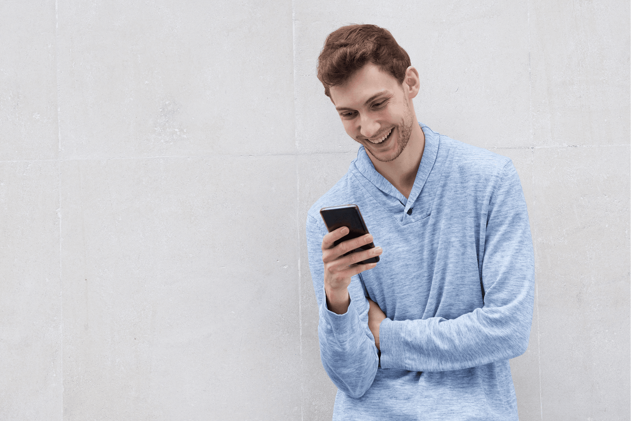 Man texting on the phone and smiling
