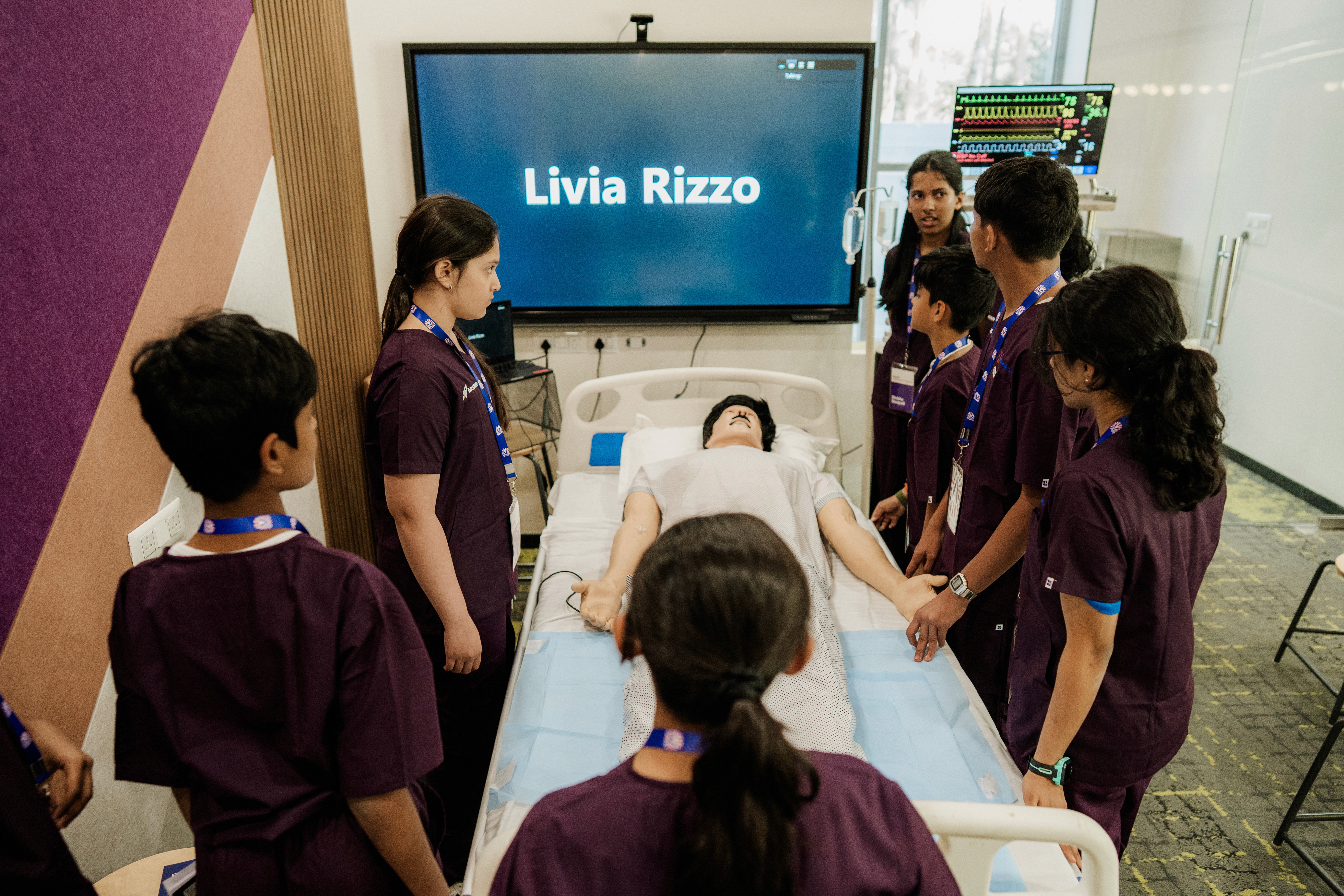 Students explore a robotic medical training manikin.