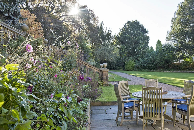 Hartingtons Heritage Tours hotel, Darley House, gardens with chairs and table