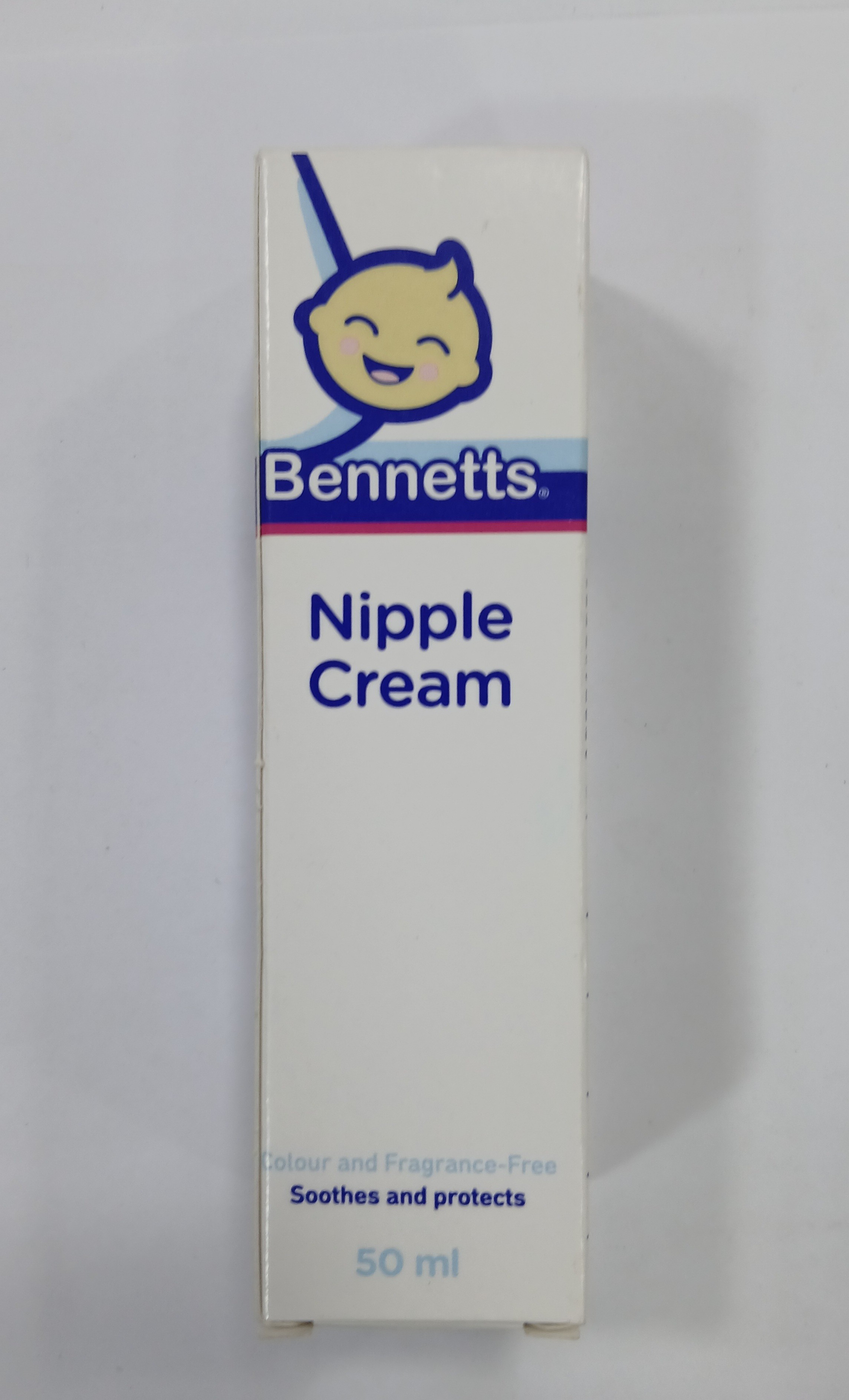 A white rectangular cardboard tube with a blue and purple label displays a smiling cartoon face, text describing it as fragrance-free and soothing, and a volume measurement of 50 ml.