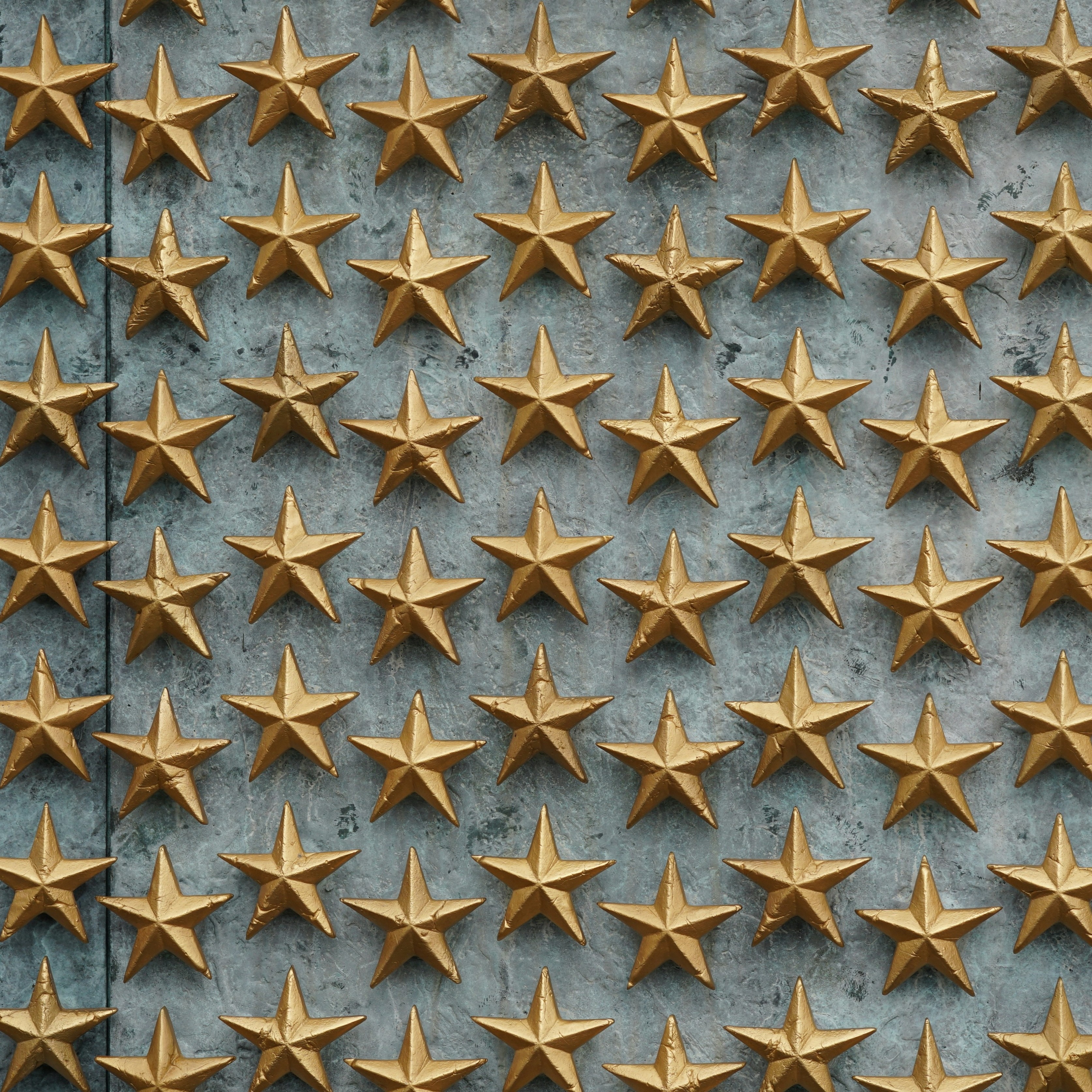 Golden stars on textured wall representing top rated bisexual affirming therapy in NYC, highlighting inclusive and supportive mental health care