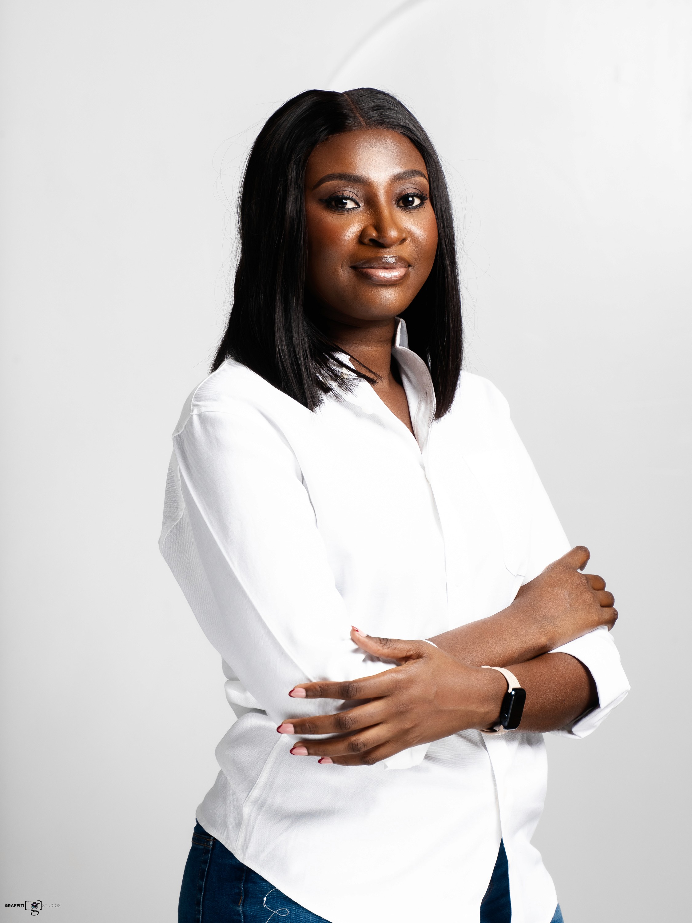 A thoughtful young person with dark hair gazes to the side, captured in soft black and white lighting.
