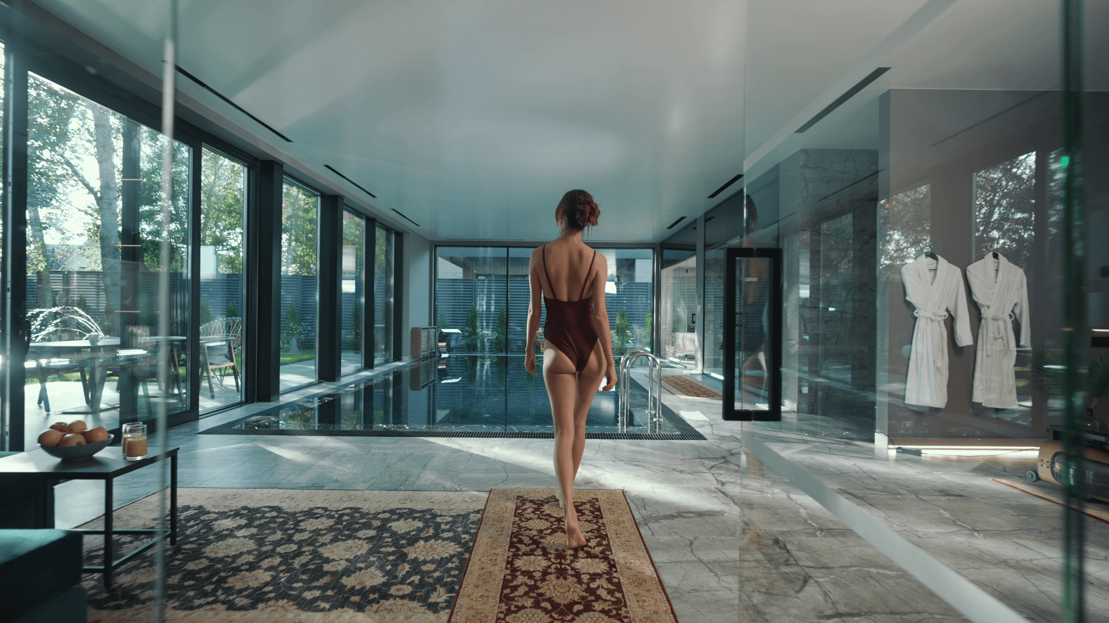 A beautiful girl is walking to the pool
